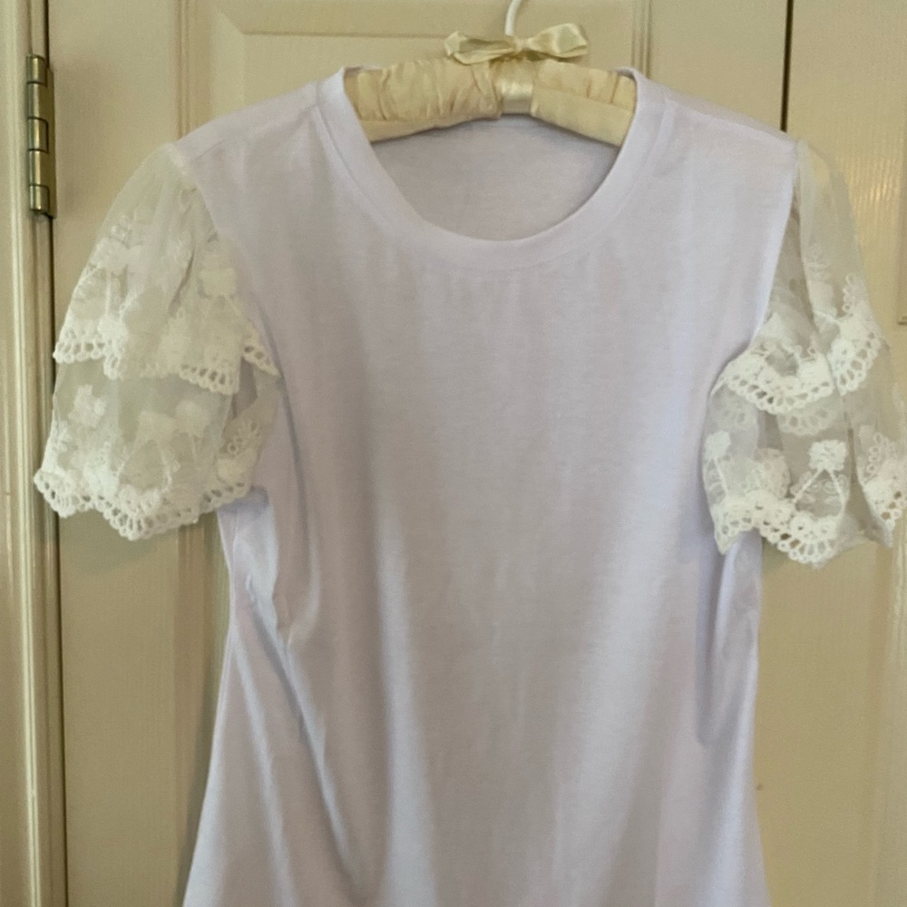 White t-shirt with lace sleeves.